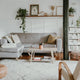 cozy modern spaces with Nordic light featuring a stylish gray couch and plants in a warm living room.