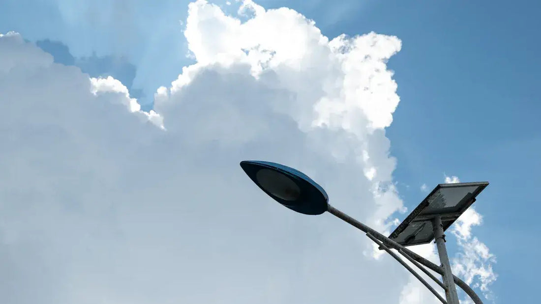 A solar lamp harnessing clean energy under a bright blue sky with fluffy clouds.