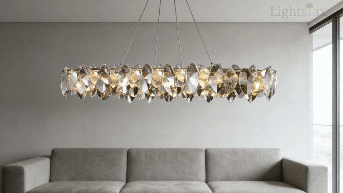 Stunning crystal chandelier above a modern gray sofa in an elegant living room, showcasing styles in the buyer's guide to crystal chandeliers.