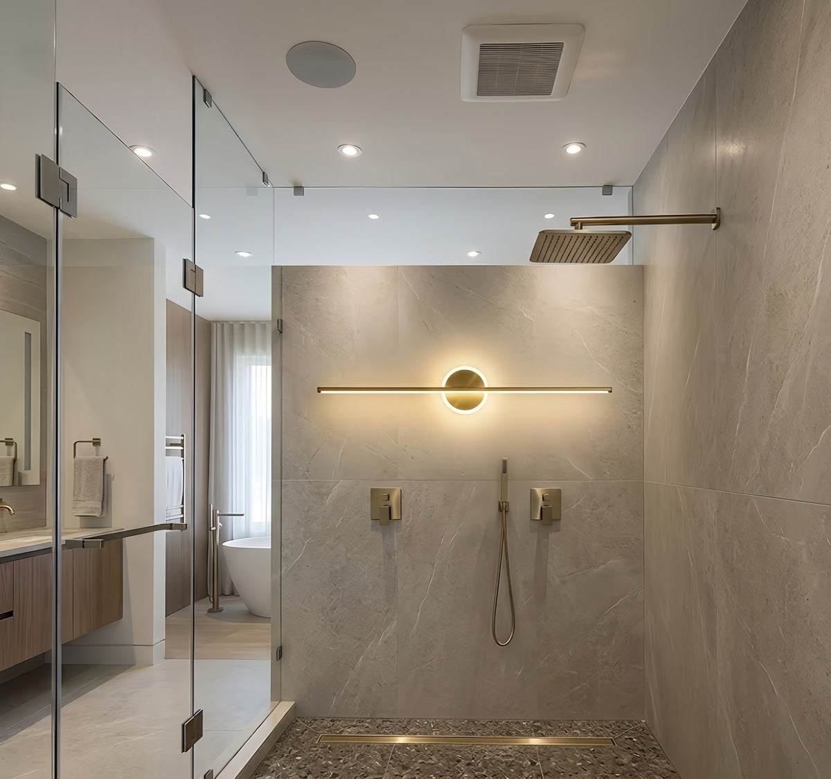 Modern bathroom shower with recessed ceiling lights, gold showerhead, and a minimalist wall-mounted light fixture.