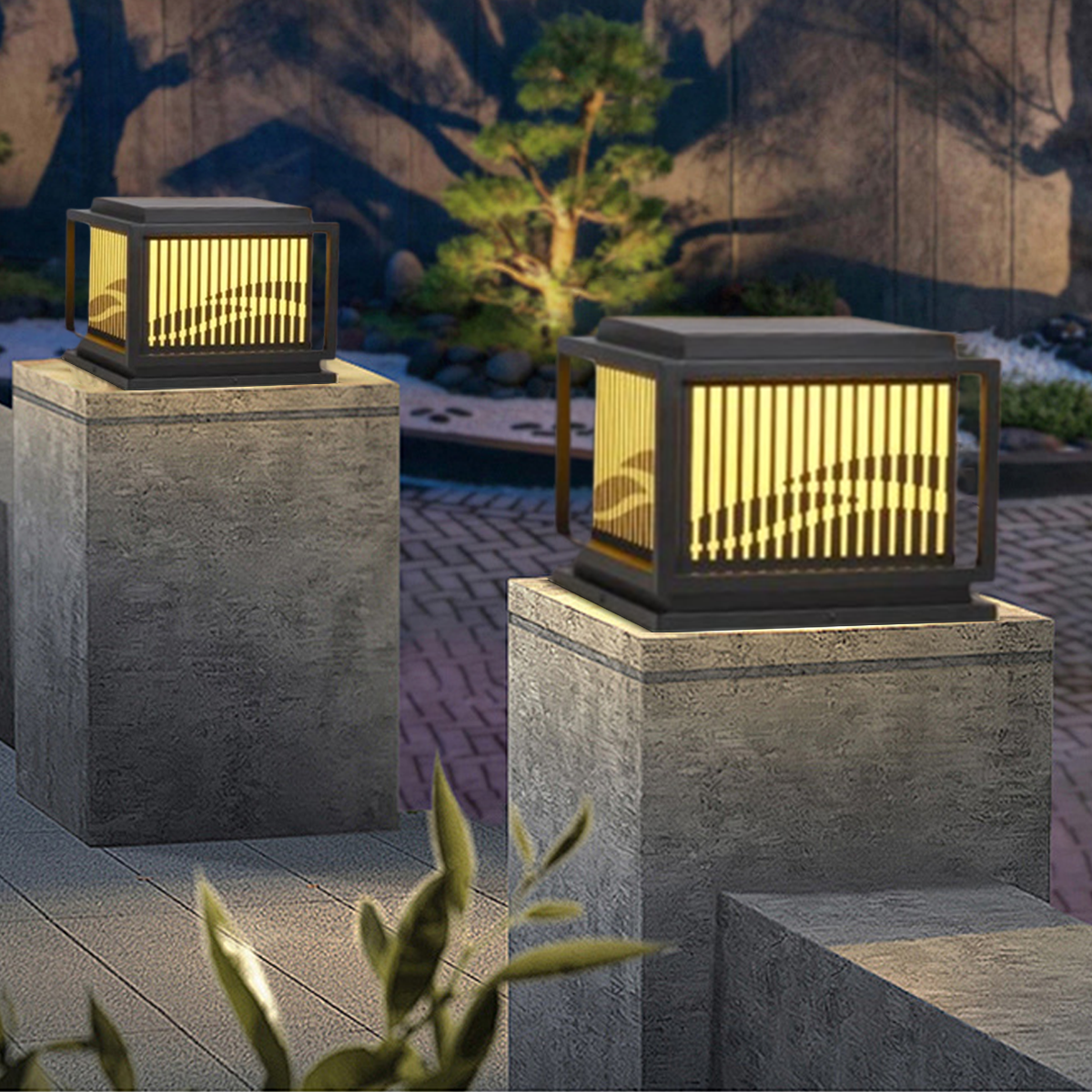 Elegant outdoor light fixtures showcasing IP ratings for light fixtures on stone pedestals in a garden setting.