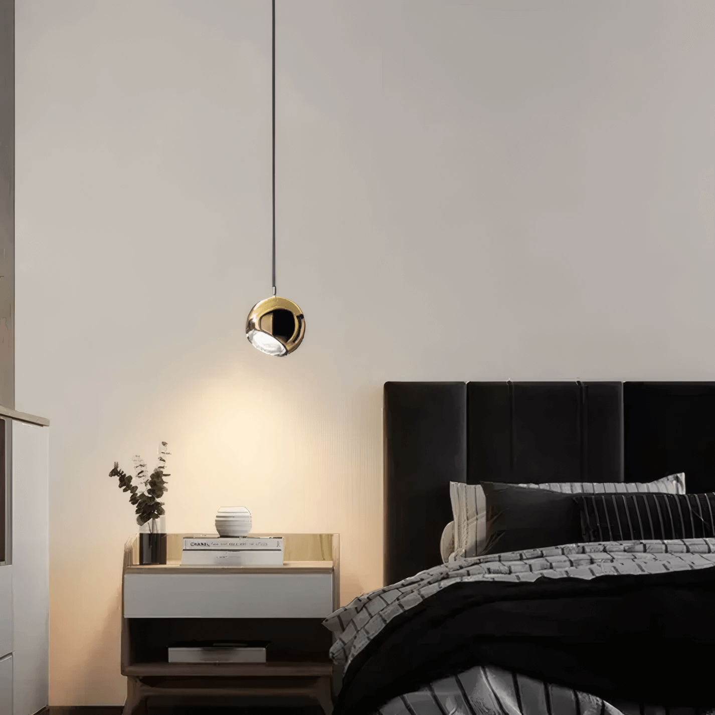 Small bedroom lighting ideas featuring a modern pendant light over a stylish bed and nightstand.
