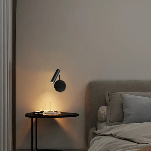Trendy wall lamps for contemporary homes illuminating a bedside table in a modern bedroom setting.