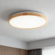 Modern bedroom ceiling lights featuring a stylish round fixture with a wooden frame.