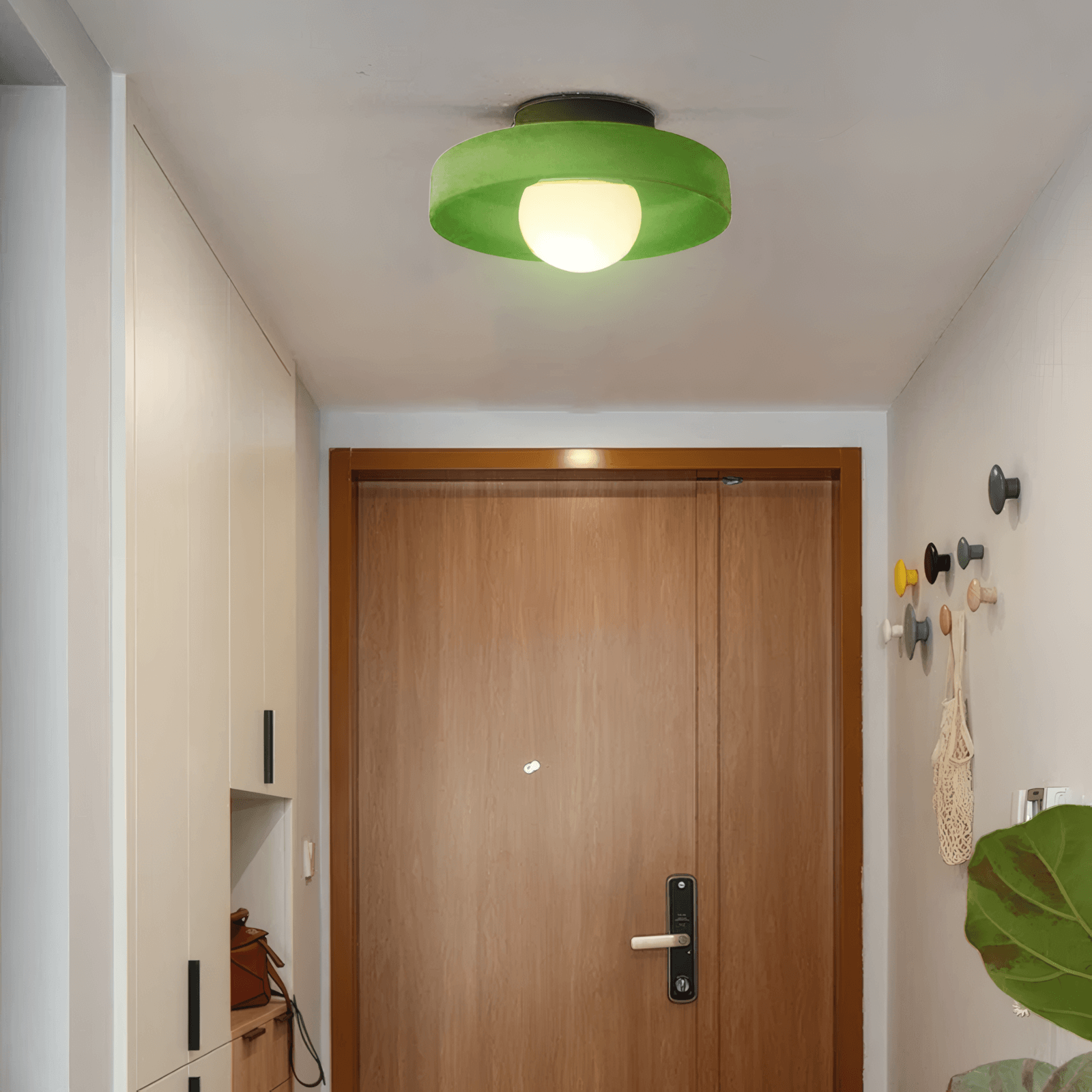 modern round ceiling light in dark green room, green metal glass